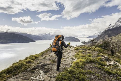 rear-view-of-female-hiker-hiking-alongside-grey-gl-2022-03-07-23-54-42-utc