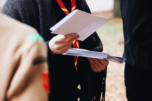 Shallow focus shot of a scout distributing white papers